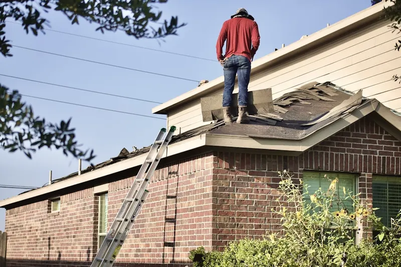Professional roofer working on a residential roof in Gunpowder Estates